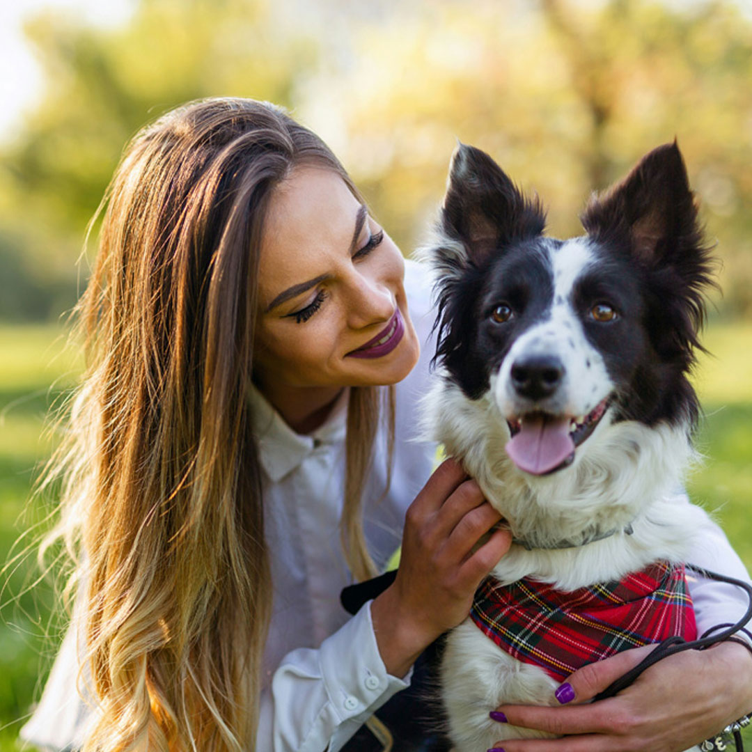 Happy moment between a woman and her dog outdoors